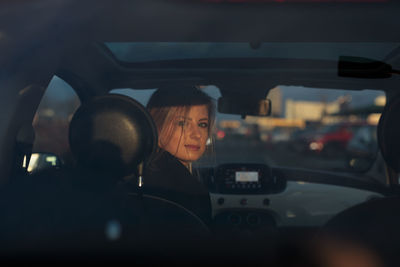 Reflection of woman in car