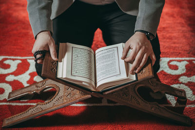 Midsection of woman reading book