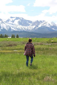Rear view of man on snowcapped mountain