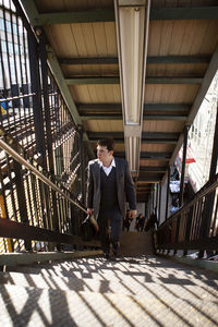 Businessman climbing stairs at railroad station