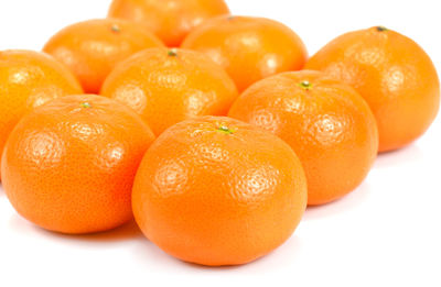 Close-up of orange fruit against white background