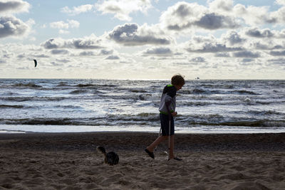 Woman with dog on beach