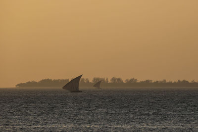 Scenic view of sea against clear sky during sunset