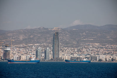 Scenic view of sea and buildings in city