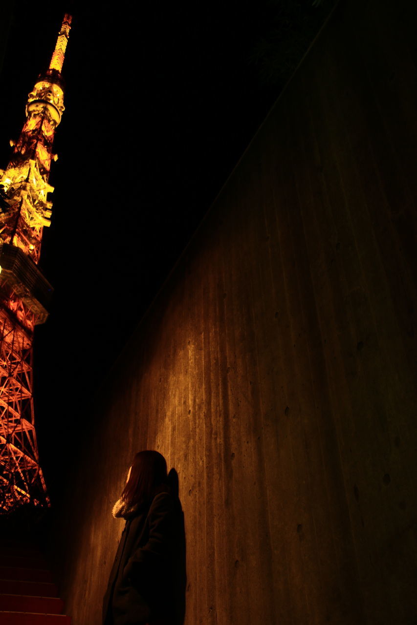 rear view, real people, built structure, night, architecture, men, building exterior, one person, women, indoors, lifestyles, spirituality, illuminated, place of worship, people