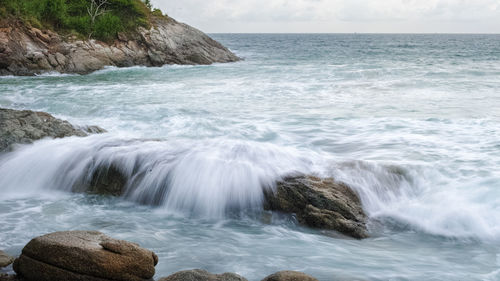 Scenic view of sea against rocks