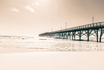 Pier over sea against sky