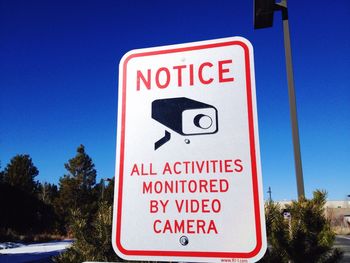 Information sign against blue sky