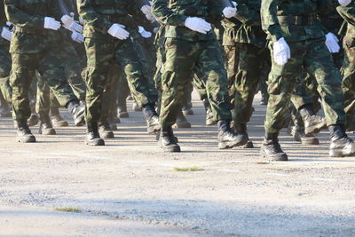 Low section of soldiers walking on road