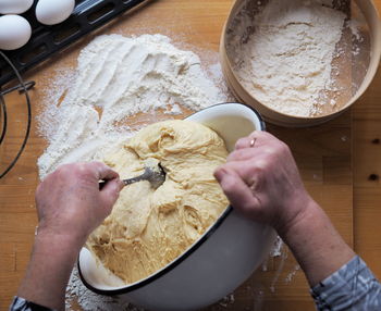The woman's hands roll out the dough.a woman's hobby.food background.