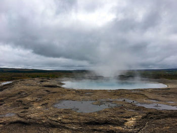 Scenic view of landscape against cloudy sky