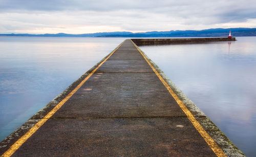 Pier over sea against sky