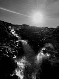 Scenic view of waterfall against sky