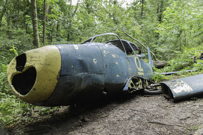 Close-up of abandoned vehicle on field