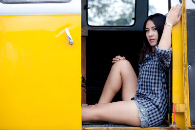 Portrait of woman sitting in land vehicle