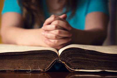 Close-up of woman reading book