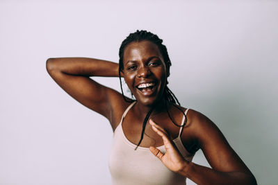 Portrait of smiling woman against white background