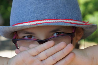 Close-up portrait of girl wearing hat