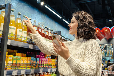 Side view of young woman looking at restaurant