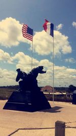 Low angle view of american flag against cloudy sky