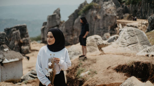 Woman standing on rock