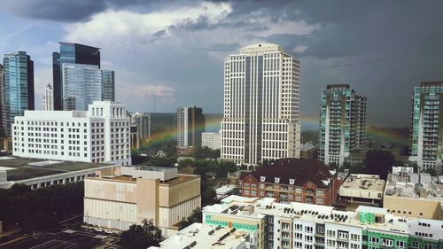 Rainbow with buildings against the sky