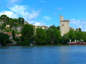 River and buildings against sky