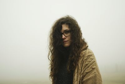 Portrait of young woman in fog