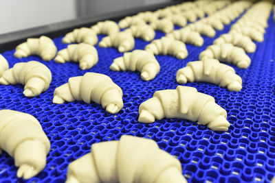 Production line in a baking factory with croissants