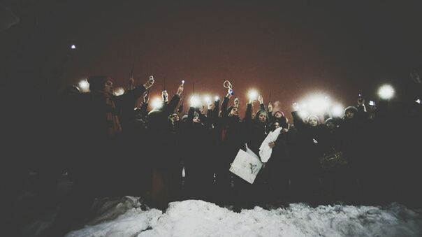 night, illuminated, large group of people, men, celebration, lifestyles, leisure activity, lighting equipment, person, arts culture and entertainment, crowd, winter, togetherness, event, enjoyment, light - natural phenomenon, snow, outdoors, building exterior