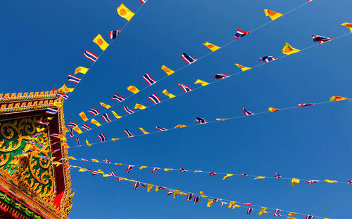 Low angle view of prayer flags against clear sky