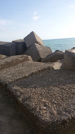 Stack of rocks on beach against sky