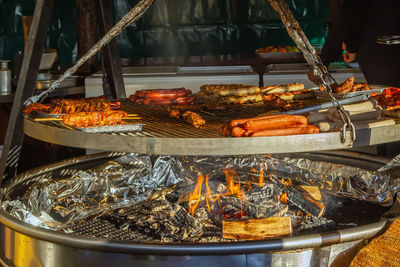 Grilled sausages of different kinds on big grill at christmas market in frankfurt am main, germany