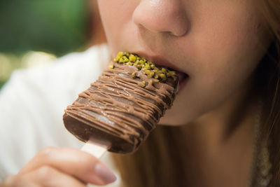 Close-up of woman eating chocolate ice cream