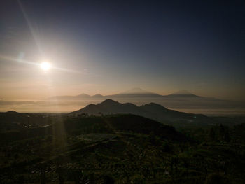 Scenic view of landscape against sky during sunset