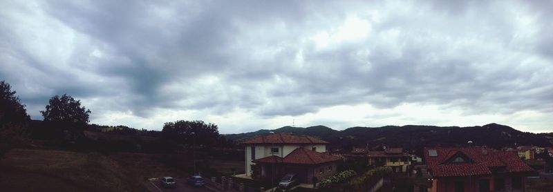 Houses against cloudy sky