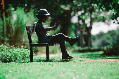 Man sitting on bench in park