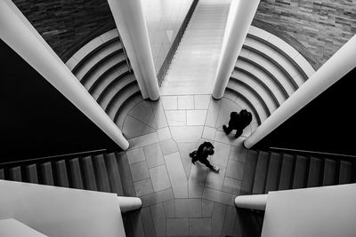 High angle view of people walking on staircase