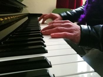 Close-up of hands playing piano