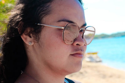 Close-up portrait of young woman wearing sunglasses