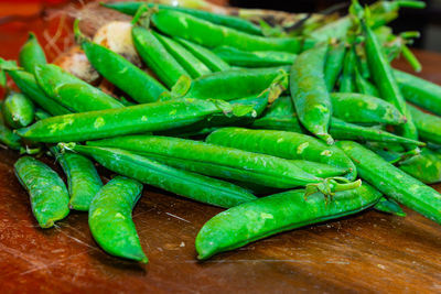 Close-up of green chili peppers on cutting board