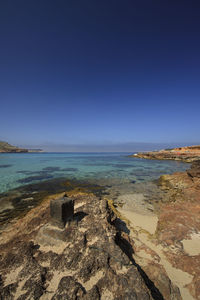 View of calm beach against blue sky