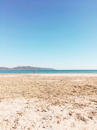 Scenic view of beach against clear blue sky