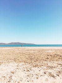 Scenic view of beach against clear blue sky