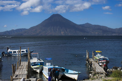Scenic view of sea and mountains against sky