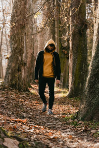 Rear view of man standing in forest