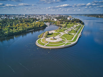 High angle view of cityscape by river against sky