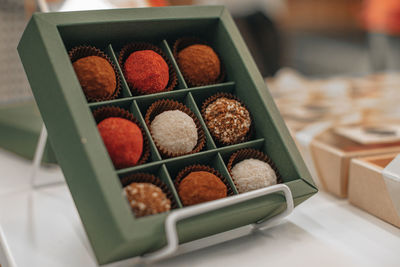 Assorted handmade truffle chocolates candies made from organic ingredients in the gift box.