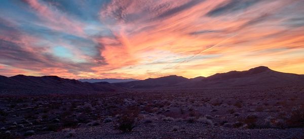 Scenic view of desert against sky during sunset