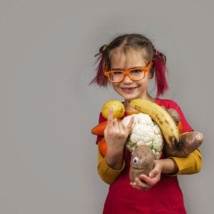 Portrait of smiling girl holding camera